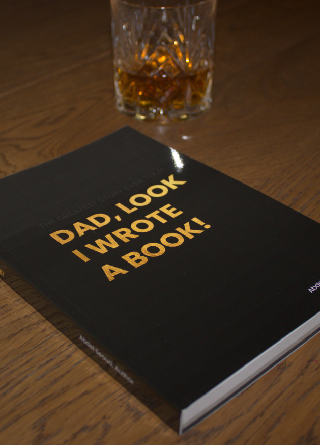 Live view of the only copy of Dad, Look - I Wrote A Book!, on a wooden table next to a glass of whisky